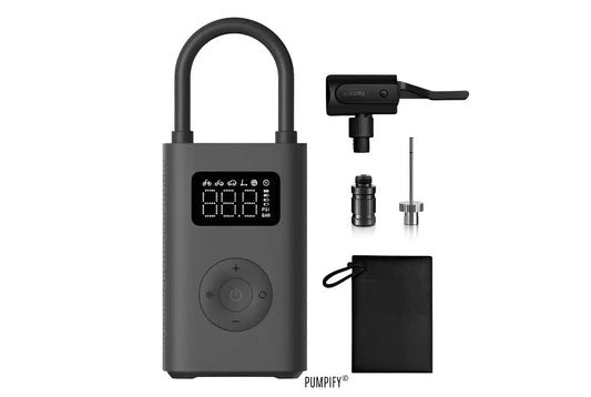 Xiaomi Mijia Portable Air Compressor 2 with various accessories including different nozzles, a power adapter, and a carrying pouch.