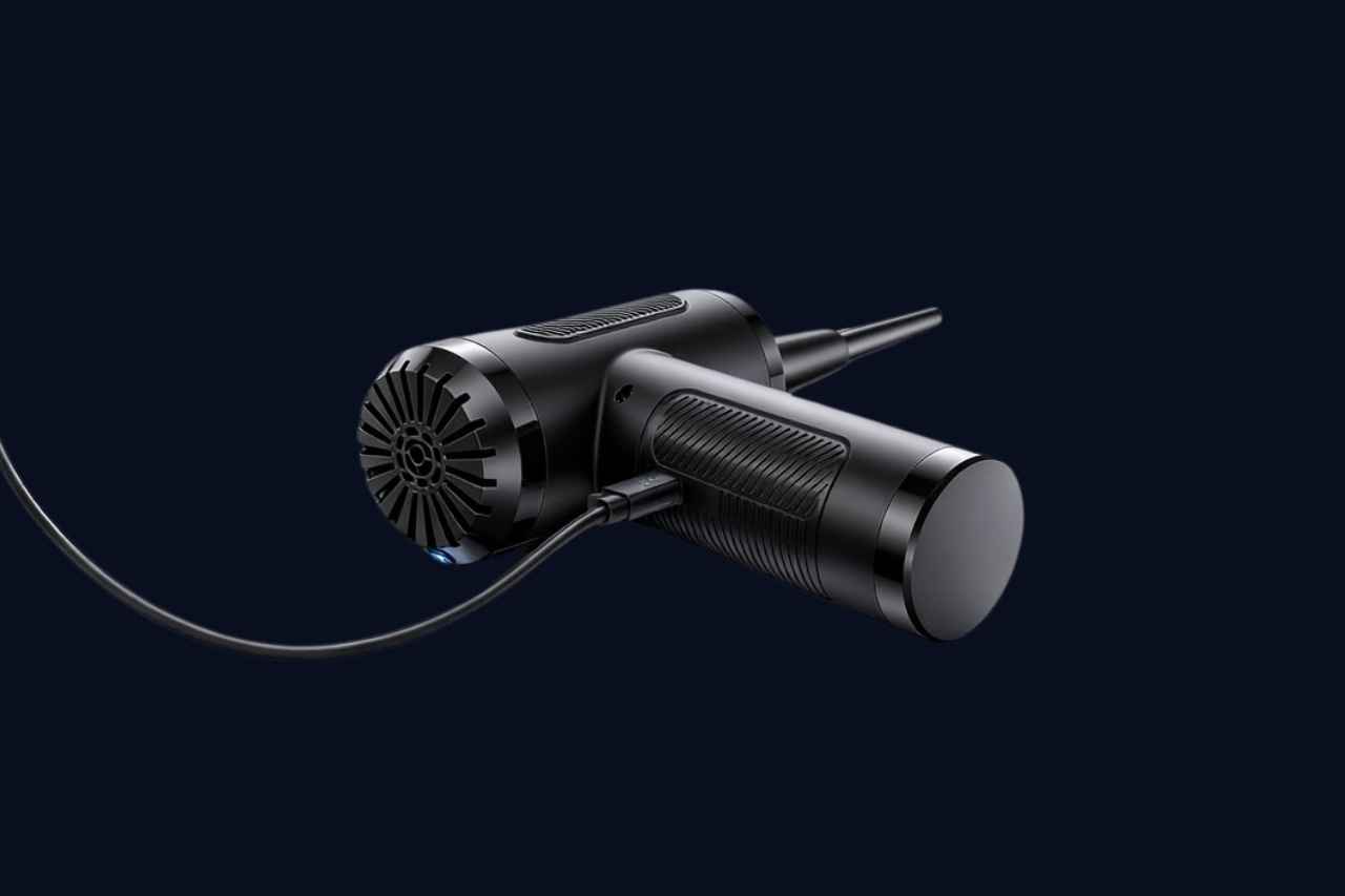 Black handheld device with a cord on a dark background