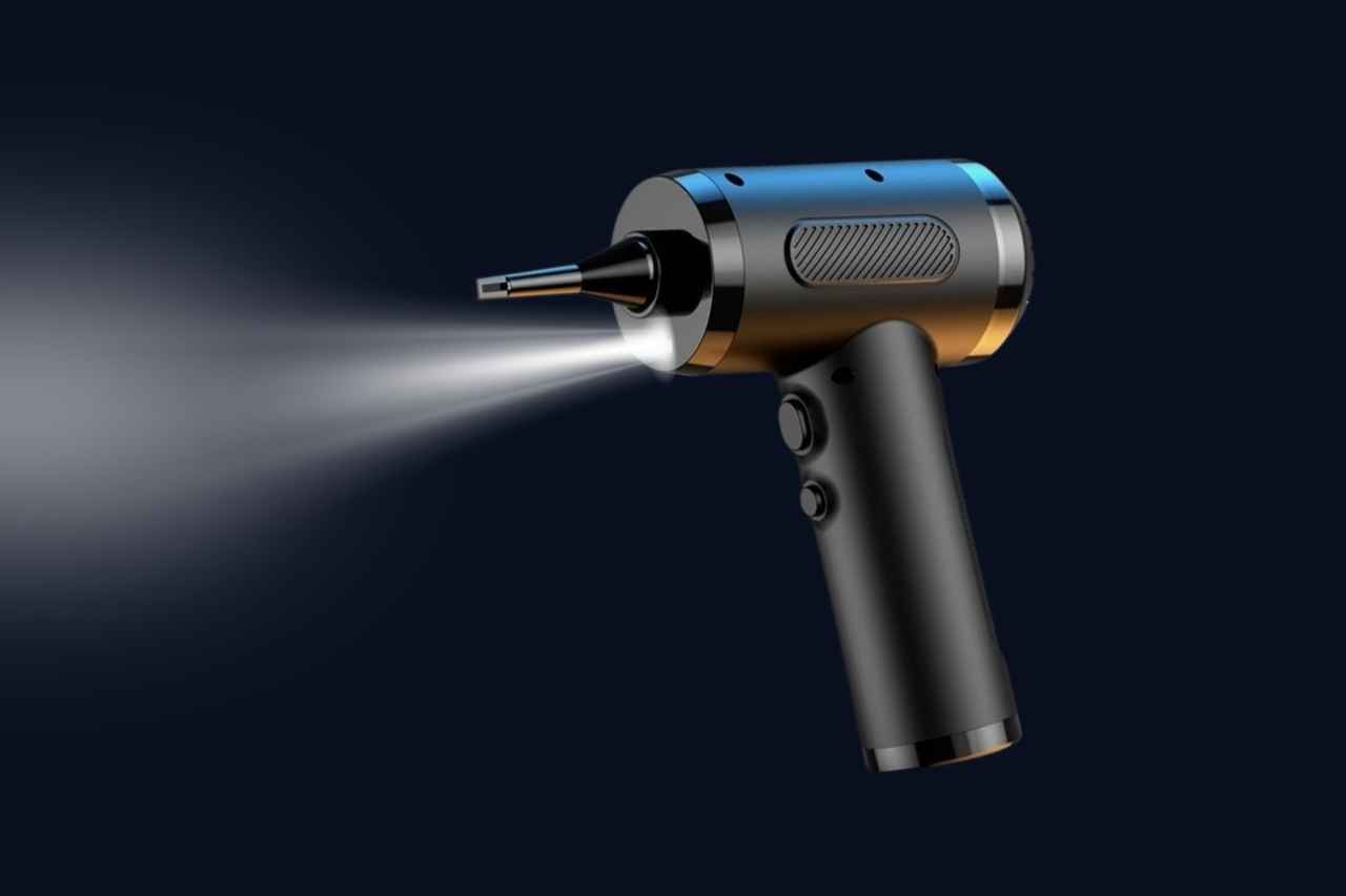 Handheld device with a nozzle emitting a beam of light on a dark background